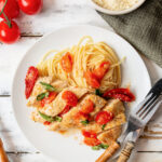 Tomato and Basil chicken in a garlic butter sauce in a cast iron skillet with sundried tomatoes