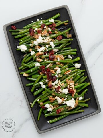 NOT YOUR MAMAS GREENBEANS - Fresh green beans topped with a Dijon Mustard Balsamic glaze, pecans, dried cranberries and feta cheese