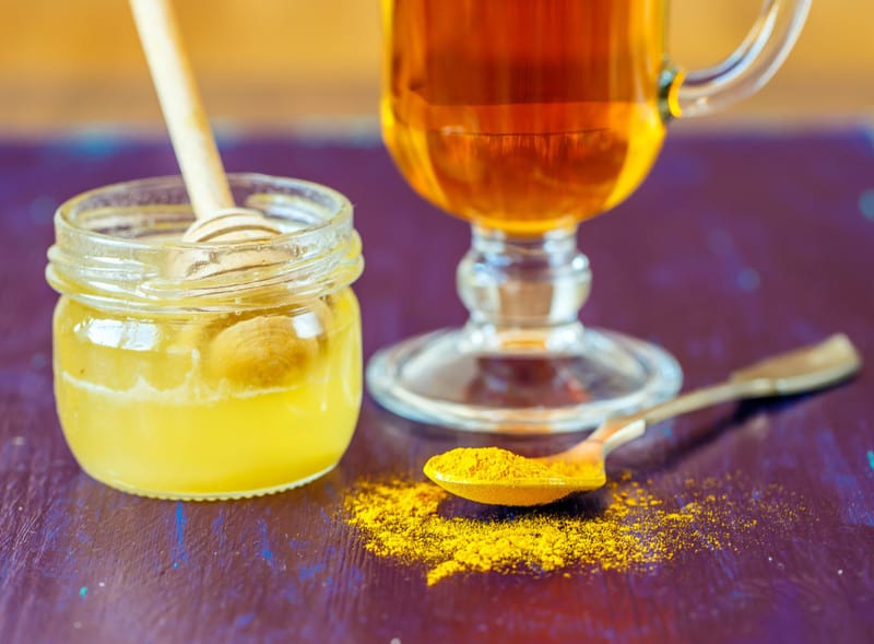 Cup of tea with honey and turmeric for detox drink