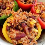close up of stuffed yellow peper with wild rice, red beans, corn in tomato sauce