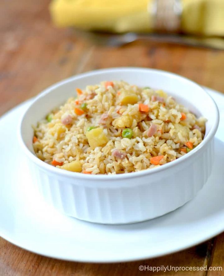 Pineapple Fried Rice with ham, peas, diced carrots in white bowl