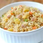 Pineapple Fried Rice with ham, peas, diced carrots in white bowl