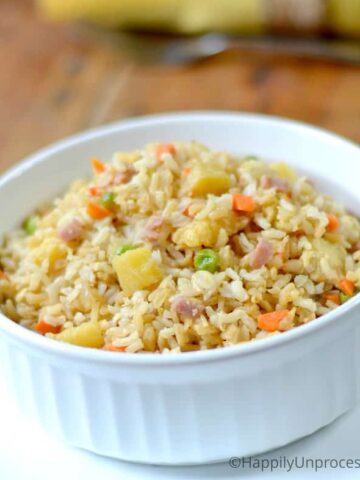 Pineapple Fried Rice with ham, peas, diced carrots in white bowl