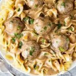 overhead shot swedish meatballs large egg noodles in white bowl