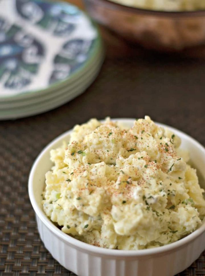bowl of potato salad garnished with parsley