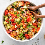 Mediterranean Chickpea and Feta Salad combined with a vinaigrette dressing in a bowl #chickpeasalad #summersalad #happilyunprocessed
