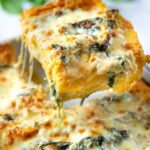 One slice of butternut squash and spinach lasagna pulled from pan