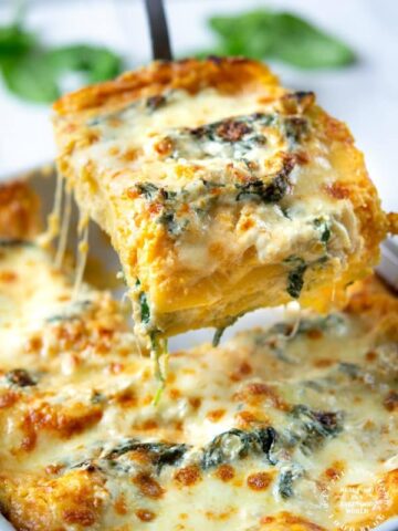 One slice of butternut squash and spinach lasagna pulled from pan