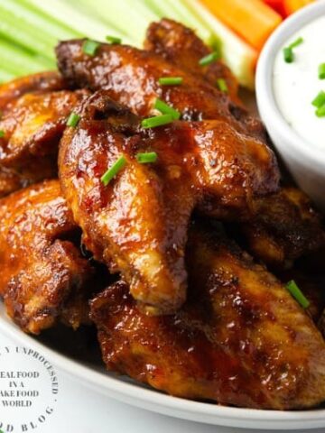 Slow Cooker Chicken wings in a tangy delicious honey buffalo sauce #chickenwings #buffalo #slowcooker #happilyunprocessed