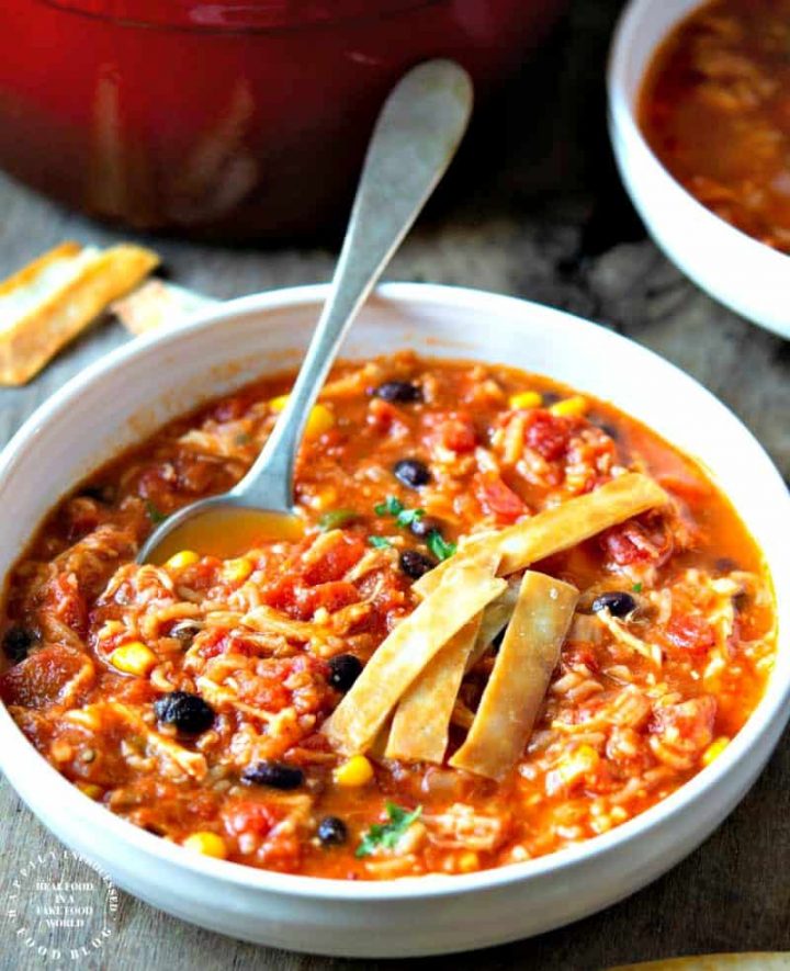 CHICKEN TORTILLA SOUP WITH RICE - perfect blend of Mexican spices, shredded chicken, corn, beans and rice for a filling bowl of soup #soup #chickentortilla #healthy #happilyunprocessed