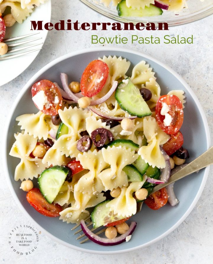 MEDITERRANEAN PASTA SALAD with bowtie pasta, red onion, cucumbers, cherry tomatoes, chick peas and feta cheese in a lemony vinaigrette #pastasalad #summer #sidedish #healthysidedish #happilyunprocessed