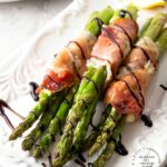 PROSCIUTTO WRAPPED ASPARAGUS - Garlic and Herb cheese is spread over prosciutto and then wrapped around fresh asparagus and baked until tender #asparagus #prosciutto #appetizer #happilyunprocessed