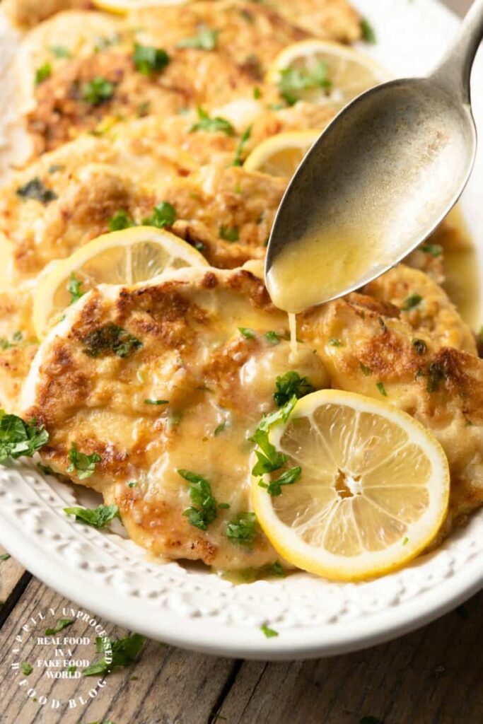 CHICKEN FRANCESE - thinly sliced chicken breasts are floured and egg dipped before sauteeing and simmering in a butter, lemon and wine sauce #chicken #francese #weeknightdinner #happilyunprocessed