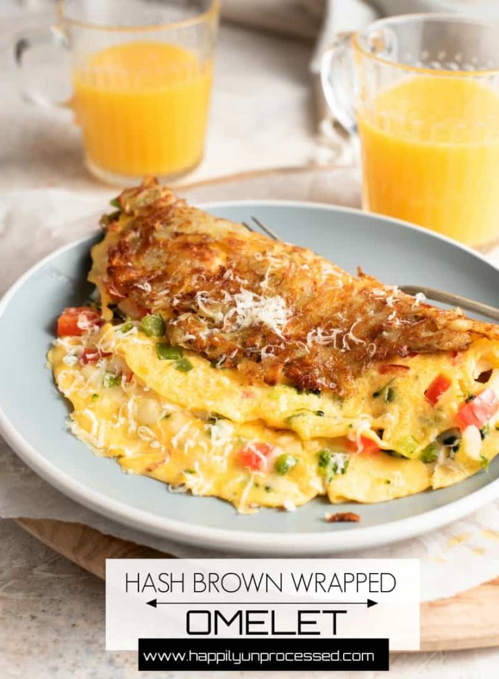 Hash Brown Wrapped Vegetarian Omelet - crispy golden hash browns form a perfect shell to wrap an omelet on the inside #breakfastfood #eggs #potatoes #hashbrowns #happilyunprocessed.com