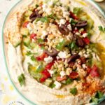 LAYERED HUMMUS DIP - Homemeade Hummus topped with Kalamata olives, cucumbers, roasted red peppers, feta cheese and pine nuts #hummus #healthy #chickpeas #tahini #happilyunprocessed