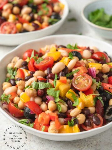 VIBRANT SUMMER 4 BEAN SALAD - 4 types of beans, colorful peppers, tomatoes, olives and red onion in a emulsified oil and vinegar dressing #summerrecipes #beansalad #potluck #healthy #summer #salads #happilyunprocessed