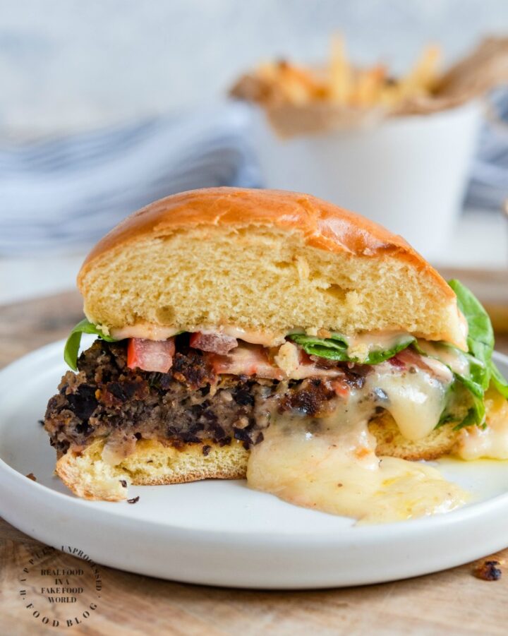 STUFFED BLACK BEAN BURGER with Monterey Jack Cheese - seasoned black beans, diced veggies, spices and cheese make up this delicious meat alternative burger #blackbeanburger #impossiblemeat #vegetarian #dinner #grill #happilyunprocessed