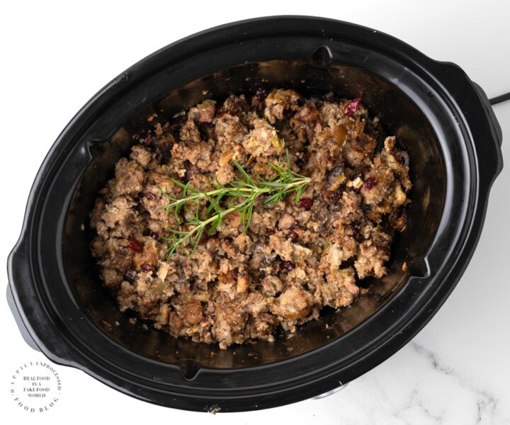 Slow cooker stuffing with sausage, cranberries, herbs and pecans. No turkey needed! The slow cooker makes the moistest best stuffing ever! #stuffing #thanksgiving #thanksgiving side dish # turkey #side dish