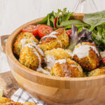 Delicious homemade falafels over green salad in falafel bowl
