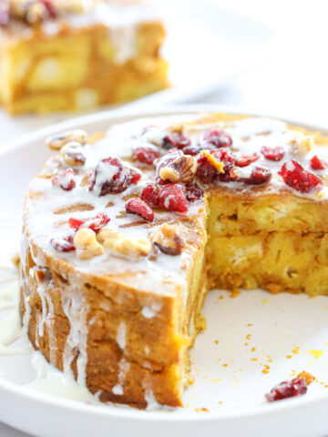 Instant Pot Pumpkin Bread Pudding on a white plate with a slice taken out