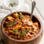 Vegetarian Lentil Mushroom Stew in a wooden earth toned bowl