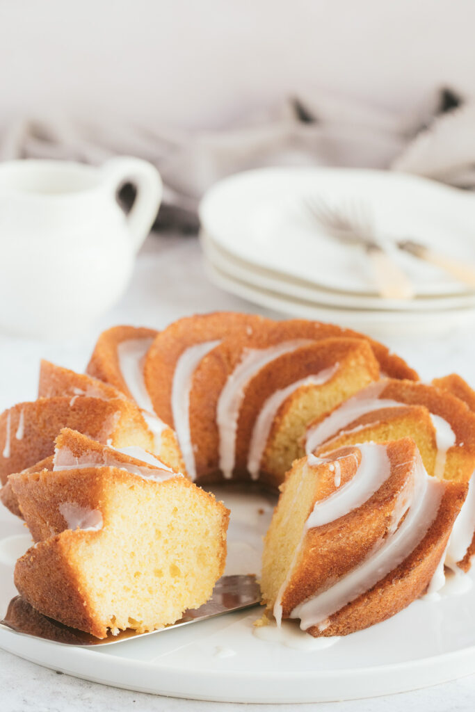 Lemon Bundt cake on a white plate with a lemon sugar glaze