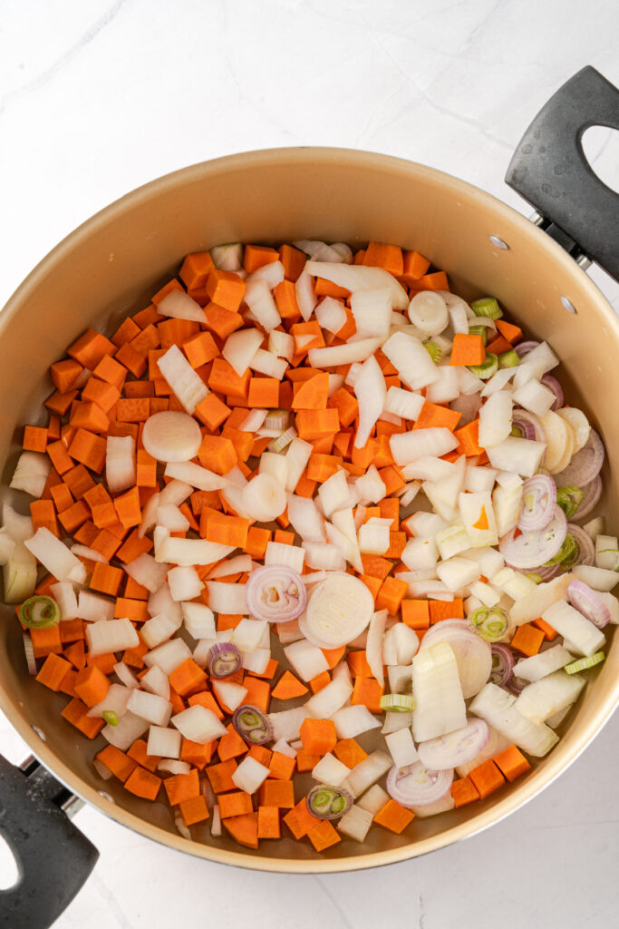 Cauliflower fried rice made with carrots onion in a pot