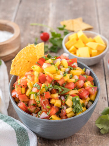 A big bowl of mango pico de gallo with tortilla chips is a healthy gluten-free vegan appetizer
