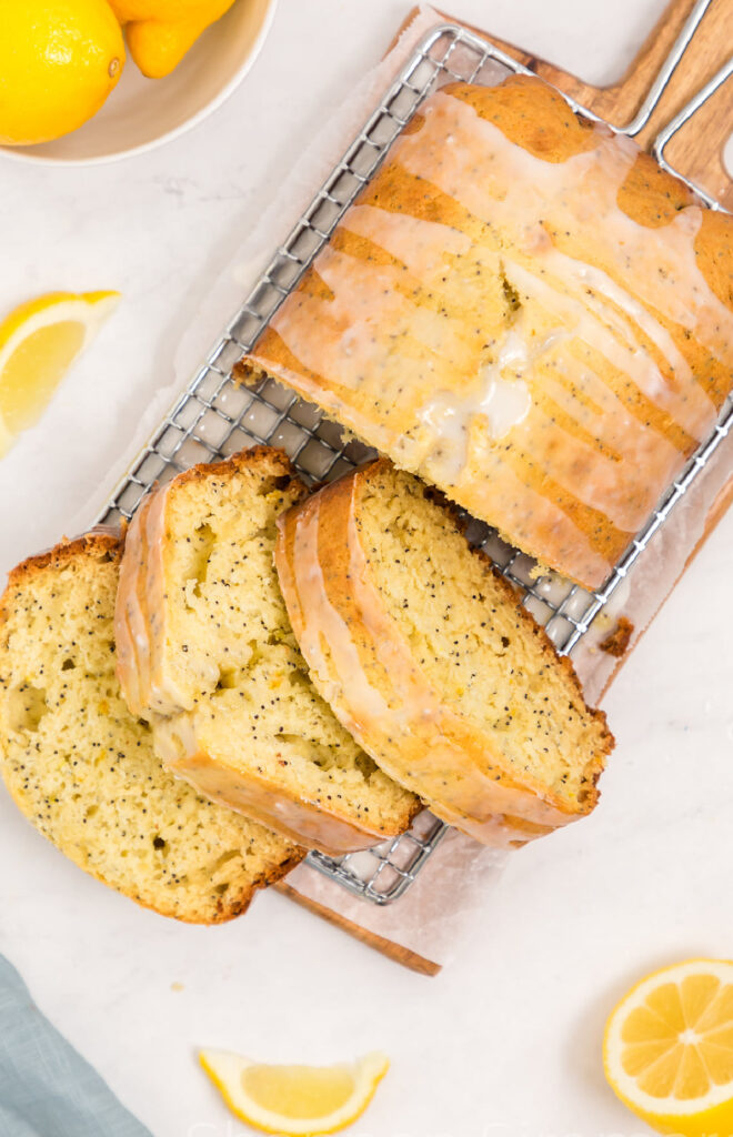 A sliced loaf of lemon poppy seed quick bread.