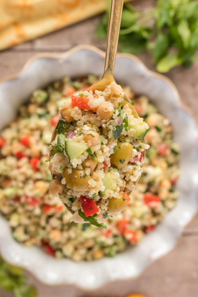 a spoonful of a delicious healthy quinoa salad with chickpeas and olives