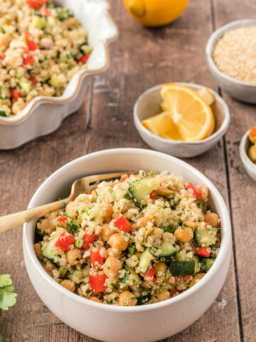 A bowl of quinoa salad with fresh cucumbers and olives