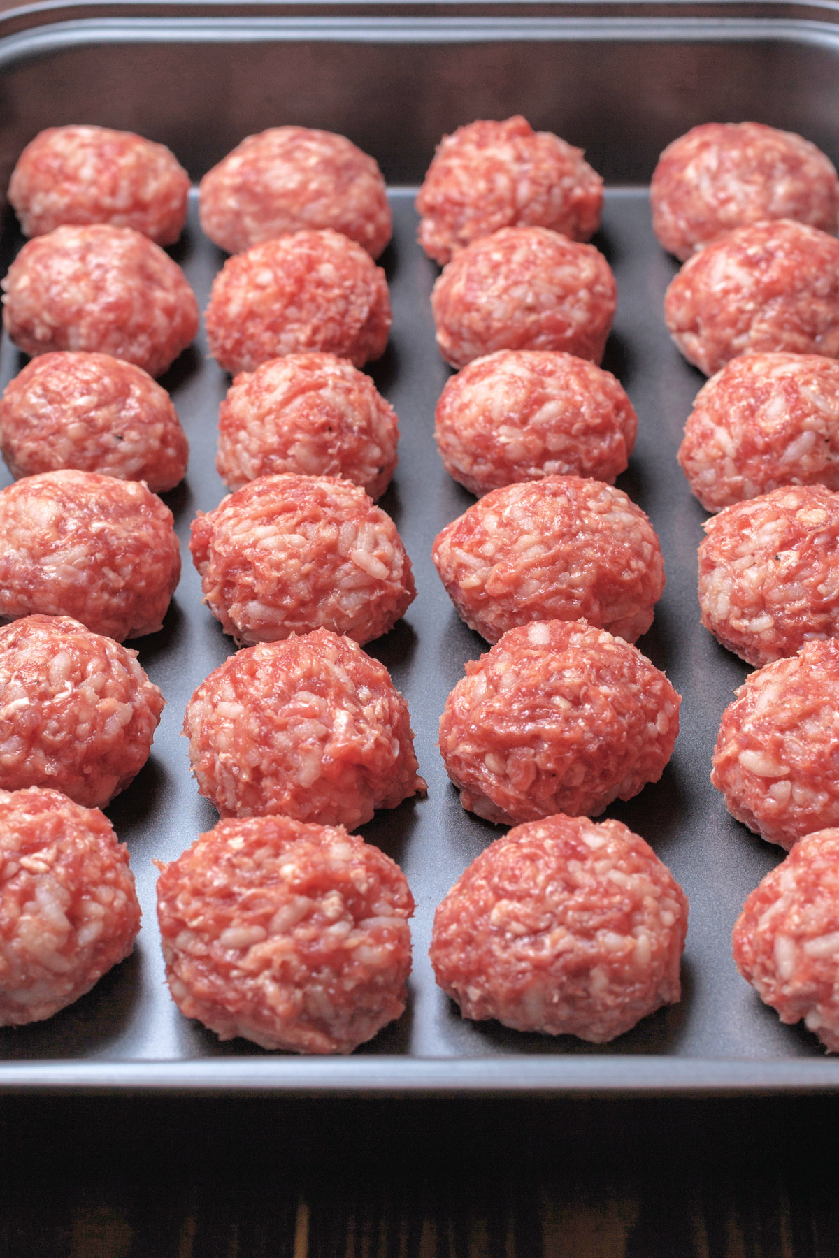 raw meatballs ready to be baked in the oven
