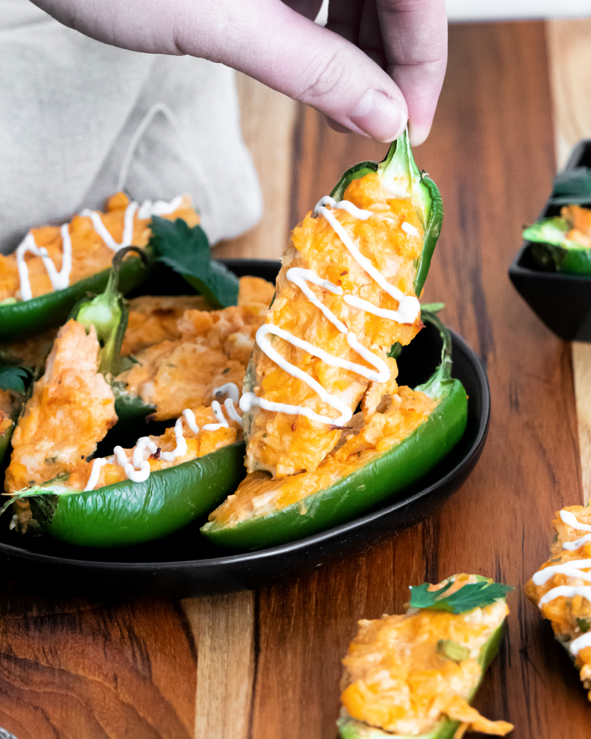 Warm, cheesy buffalo chicken jalapeno poppers on a plate 