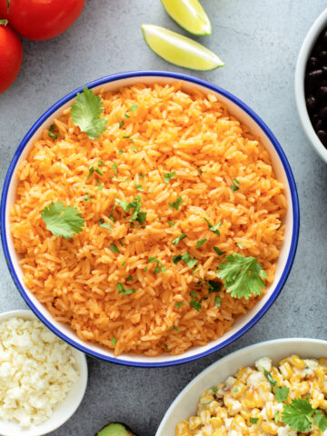Homemade Yellow Mexican Rice in a blue bowl with fresh cilantro