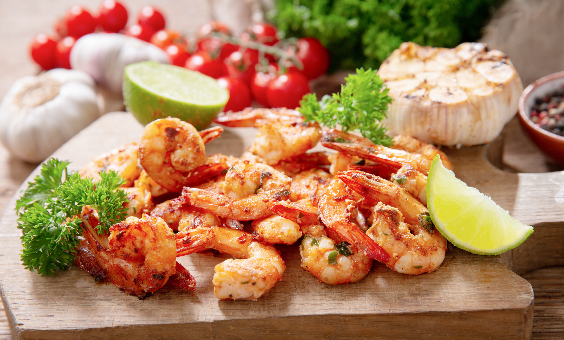 This image has an empty alt attribute; its file name is Roasted-garlic-shrimp-cocktail-on-a-brown-cutting-board-1.jpg