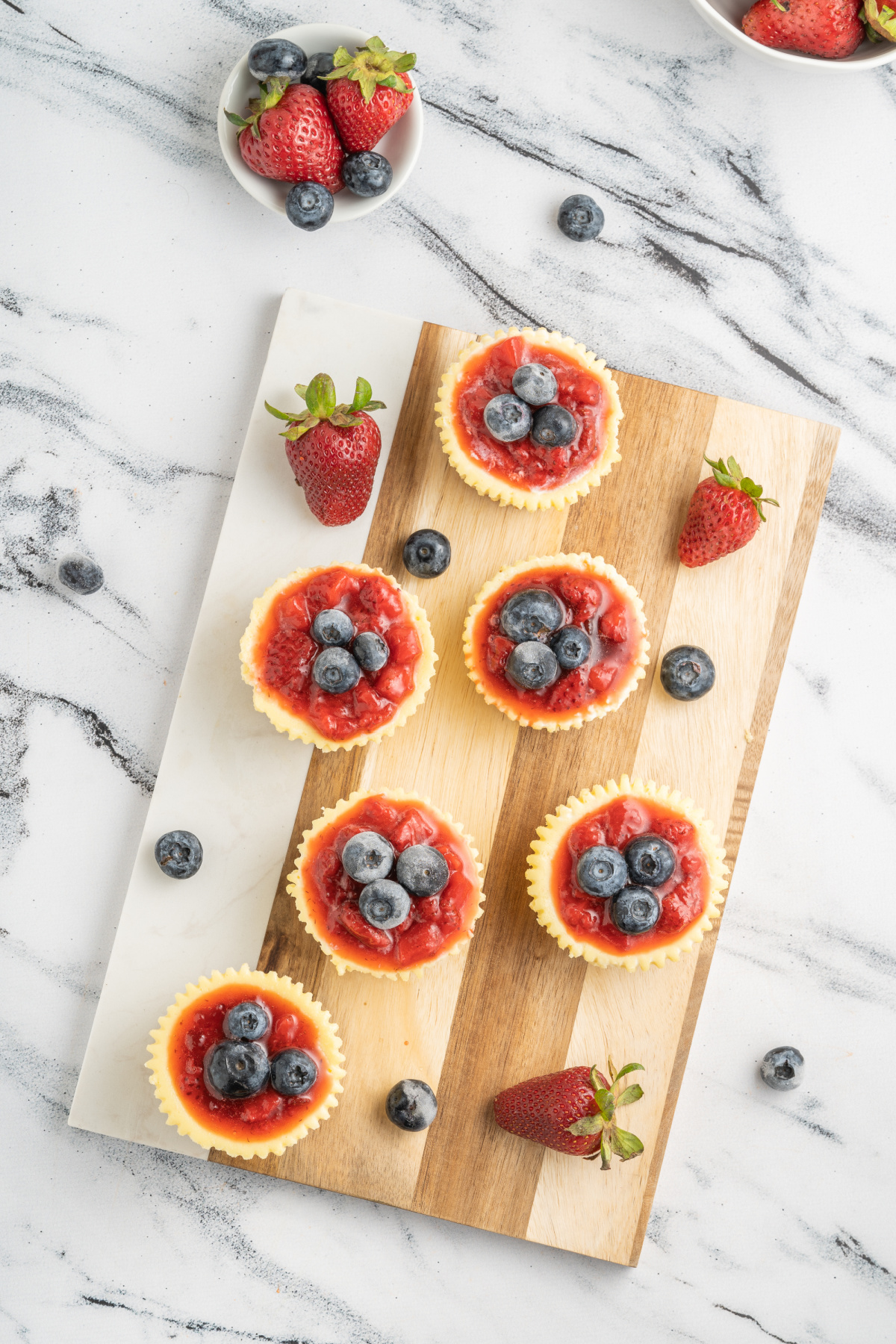 Delicious mini cheesecakes made with a graham crust topped with strawberry puree