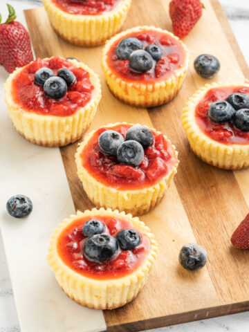 Delicious mini cheesecakes with a graham cracker crust and blueberries on top