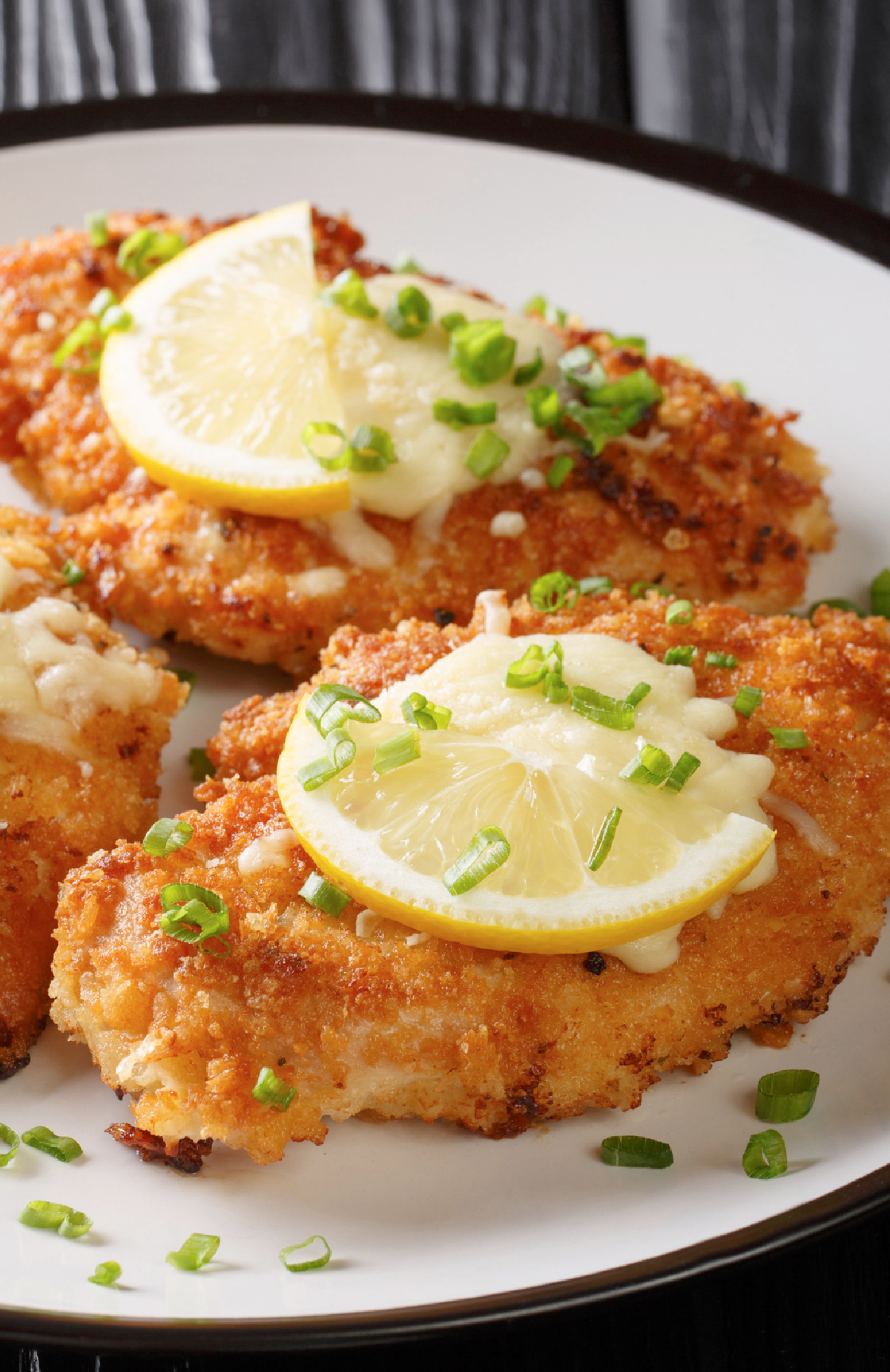 A plate of chicken breasts that have been baked in a garlic infused oil