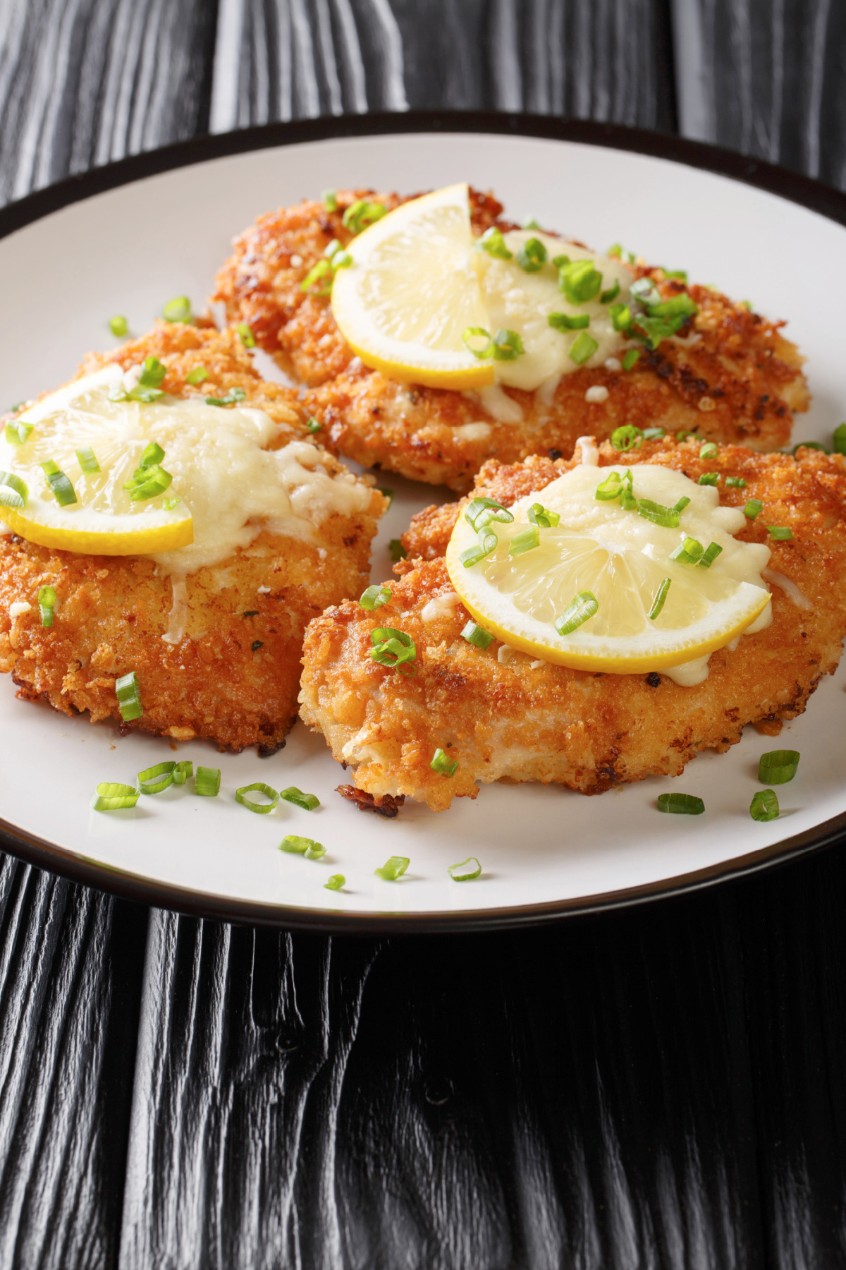  a plate of chicken breasts that have been baked in a warm garlic infused oil that come out crispy and golden