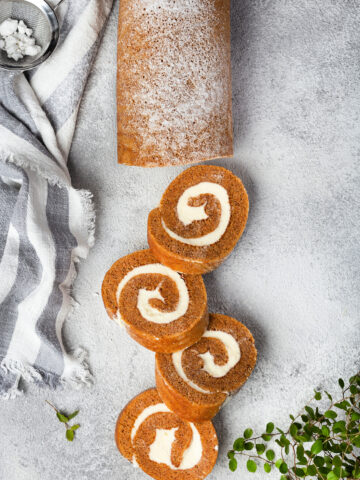 Pumpkin cake roll with cream cheese filling and powdered sugar