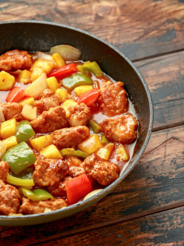 Sweet and sour chicken with pineapple and bell peppers over rice