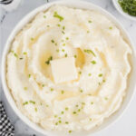 Garlic mashed potatoes with chives and butter in a bowl.