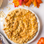a big bowl of pumpkin spiced overnight oats topped with cinnamon and pecans
