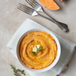 a bowl filled with homemade warm sweet mashed potatoes for Thanksgiving