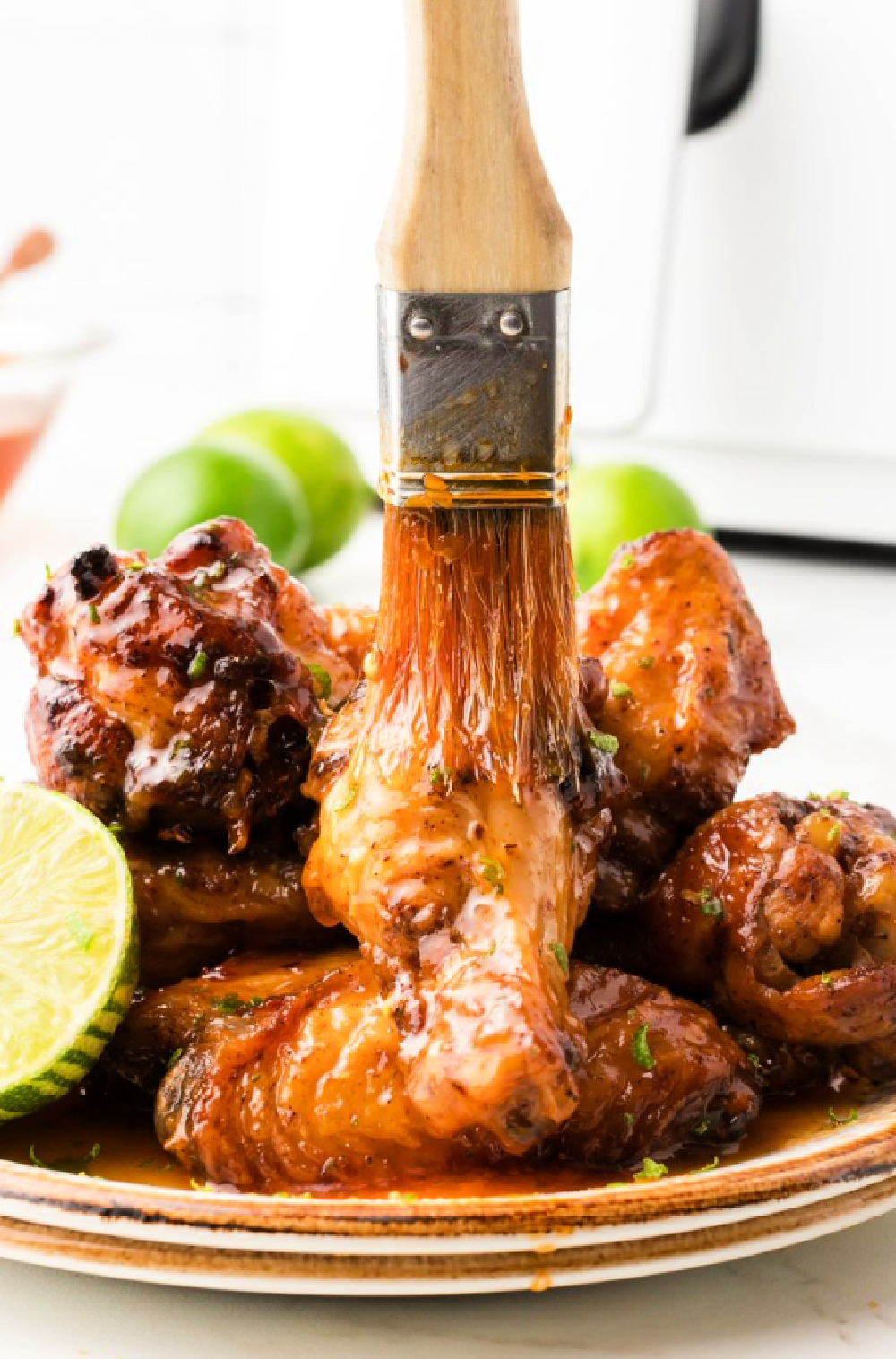 Grilled chicken wings and drumsticks with a dry rub and then brushed in a honey lime glaze