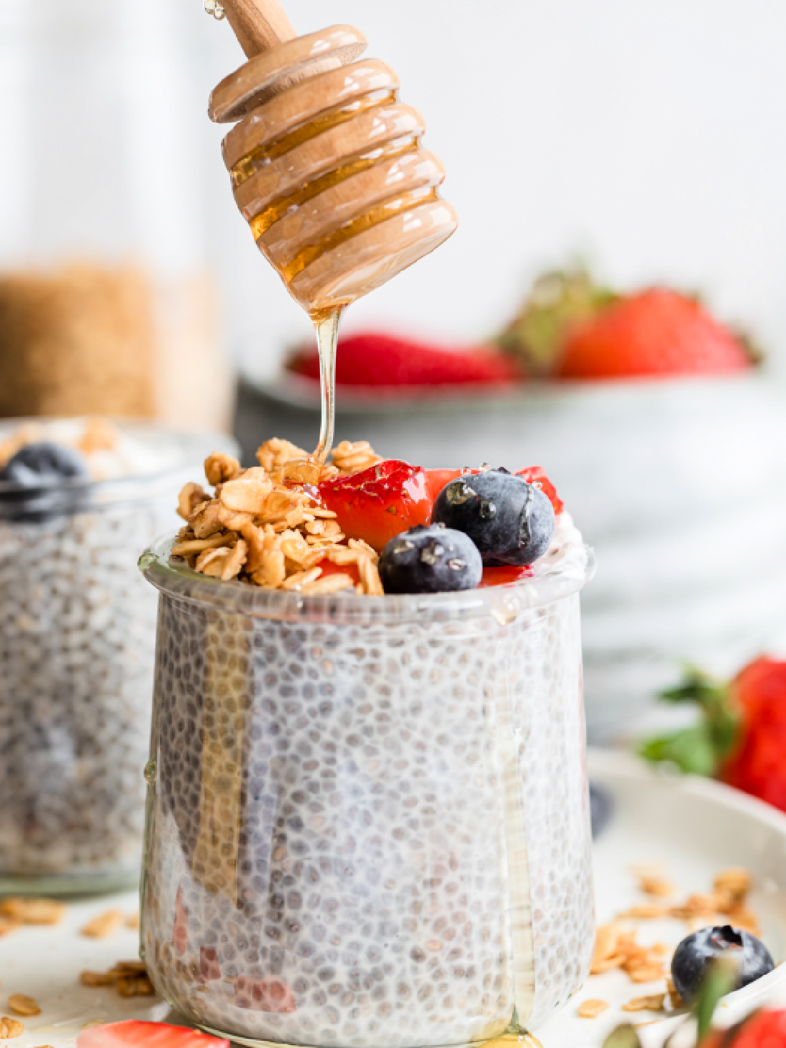 Overnight chia seed pudding with coconut milk, almond milk, vanilla and topped with berries and honey