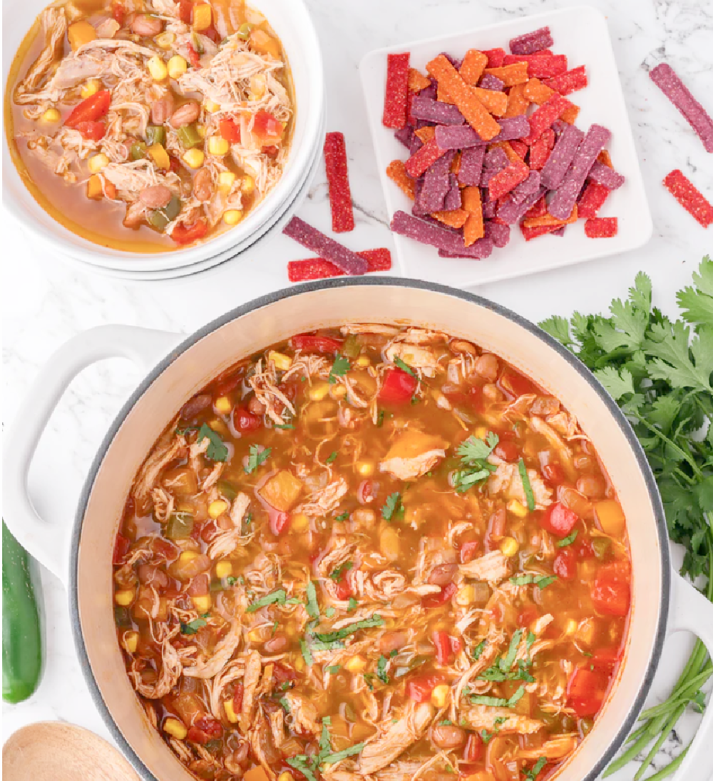 A big pot of southwestern fiesta taco soup with chunks of chicken, corn, beans and spices