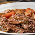 SLOW COOKER POT ROAST WITH CARROTS, POTATOES MUSHROOMS IN GRAVY